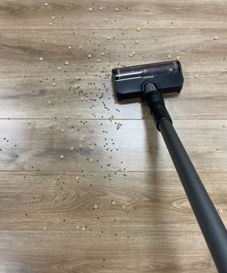 Miele Duoflex vacuuming cereal and lentils on wooden floor