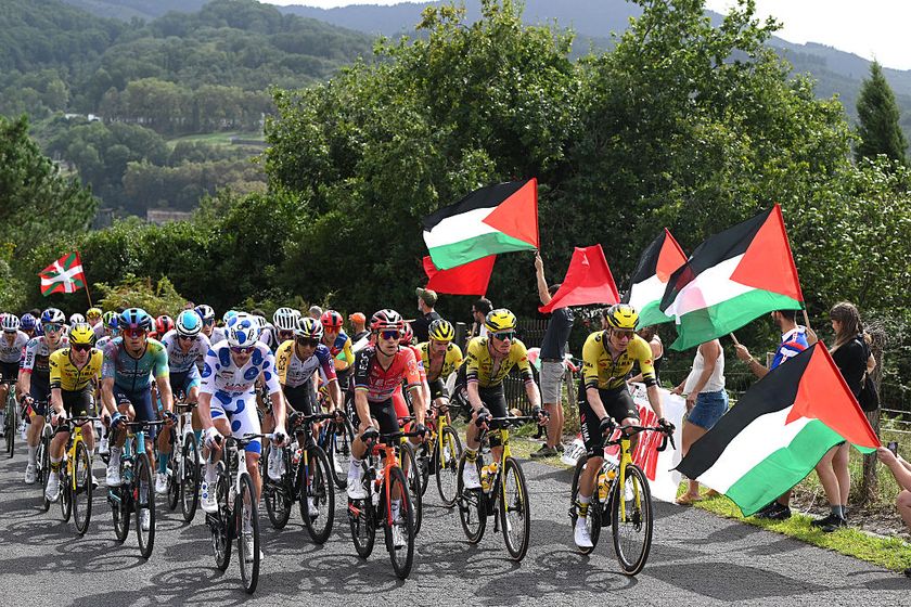 BILBAO, SPAIN - SEPTEMBER 03: Jay Vine of Australia and UAE Team Emirates - XRG - Polka dot Mountain Jersey, Egan Bernal of Colombia, Michal Kwiatkowski of Poland and Team INEOS Grenadiers, Dylan Van Baarle of Netherlands and Team Visma | Lease a Bike and a general view of the peloton competing while a group of fans protest displaying Palestinian flags during the La Vuelta - 80th Tour of Spain 2025, Stage 11 a 157.4km stage from Bilbao to Bilbao / #UCIWT / on September 03, 2025 in Bilbao, Spain. (Photo by Dario Belingheri/Getty Images)