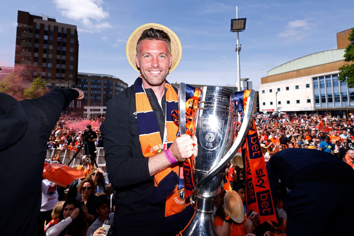 Luton Town manager Rob Edwards holds the Championship play-off trophy during celebrations in Luton town centre, 2023