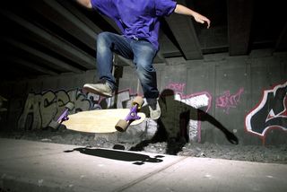 A teen rides on his longboard