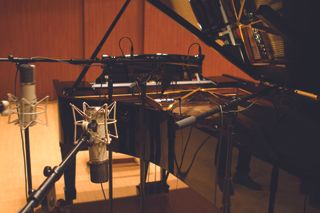 Recording studio with microphones and piano