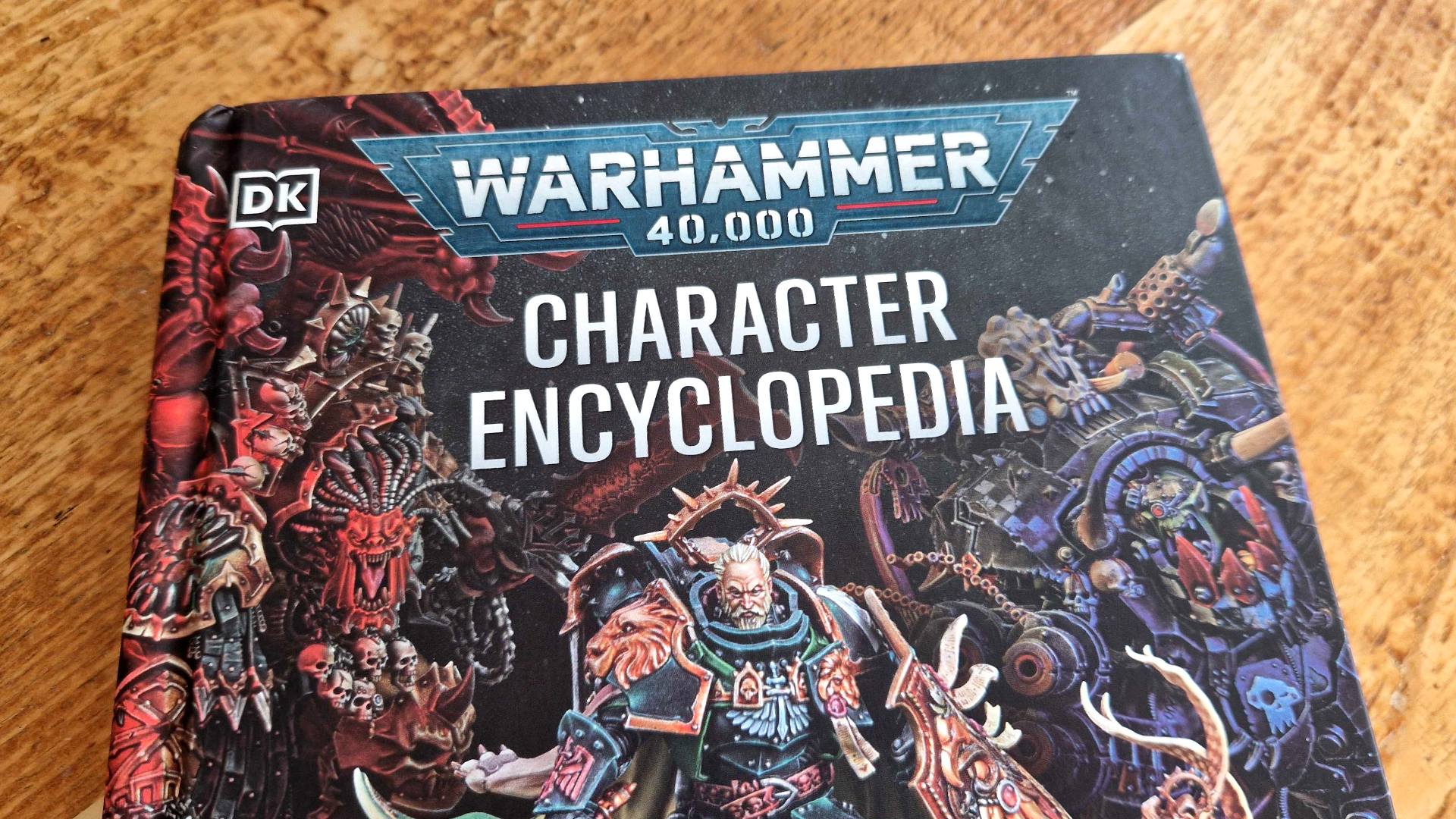 Warhammer 40,000 Character Encyclopedia on a wooden table