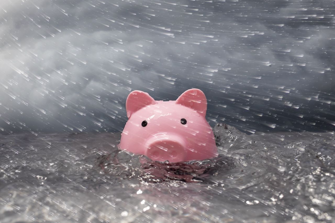 Piggy bank in a storm to depict retirement uncertainty 