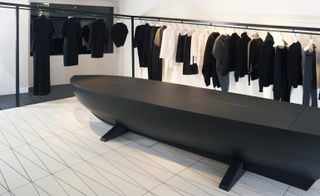 Clothes rails with a black seating area