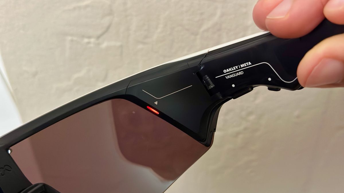 A close-up of the Oakley Meta Vanguard glasses' inner-right arm and right lens, where a red Status LED is visible along the right lens's edge.