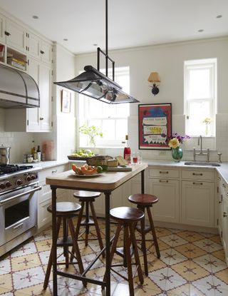 Small beige kitchen with terracotta tiled flooring