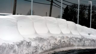 New cars are shown buried under snow after an intense lake-effect snowstorm