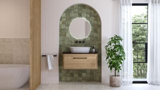 bathroom with wooden slatted screen to side of freestanding bath, green tiled arch recess with wooden wall mounted vanity unit, white sink, wall mounted black tp and mirror, black french doors with white floor to ceiling voile in front