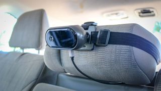 The Tiny Traveler camera mounted with headrest strap