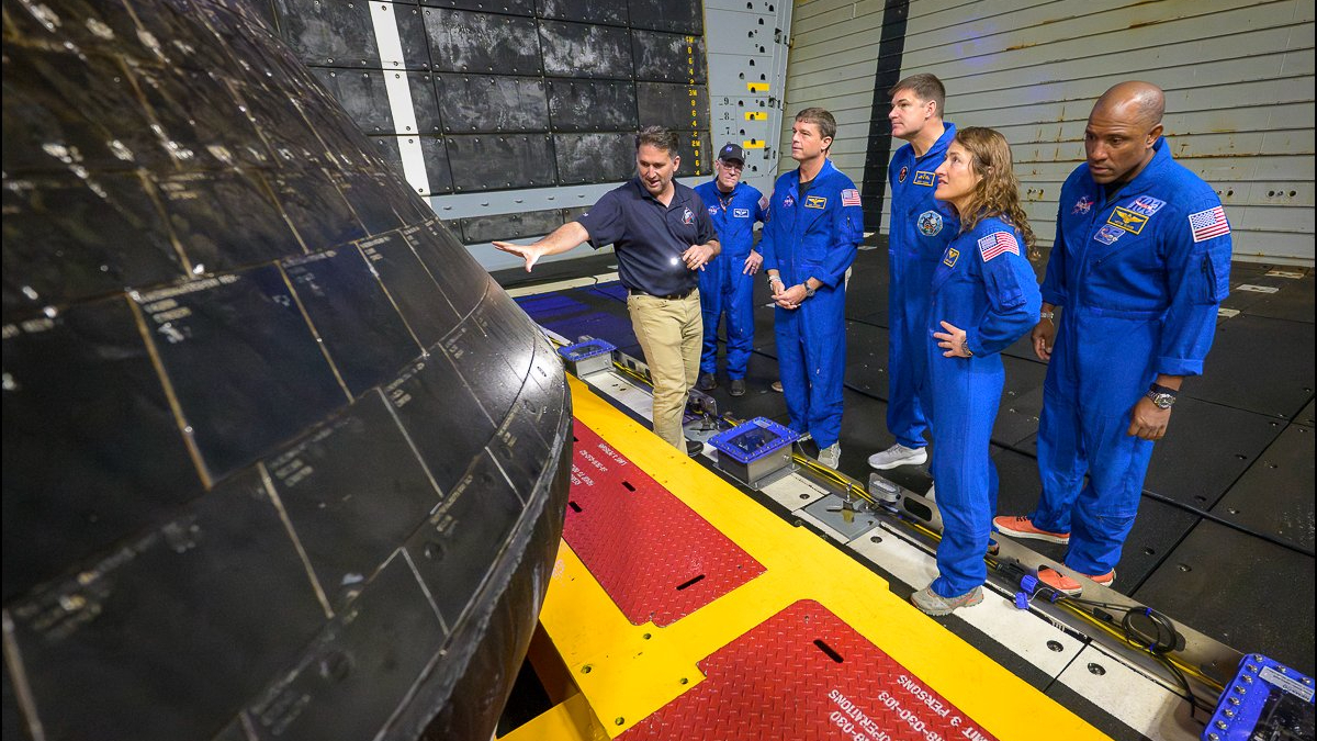 The four Artemis 2 astronauts (at right) inspect their Orion capsule &ldquo;Integrity&rdquo; in the well deck of the USS John P. Murtha on April 11, 2026, in the Pacific Ocean off the coast of California. Integrity splashed down a day earlier, ending the 10-day Artemis 2 moon mission.