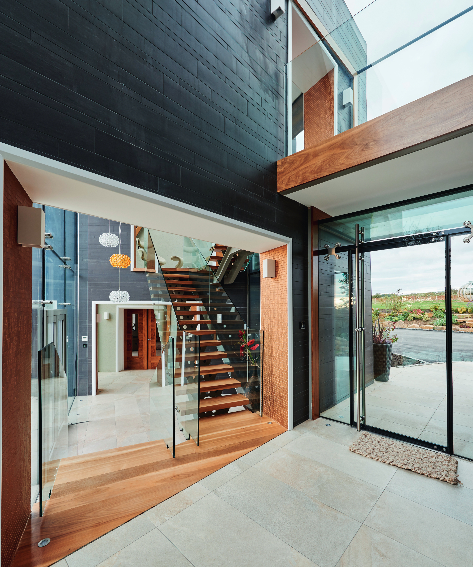 inside of self build with glass and wooden staircases and walkways