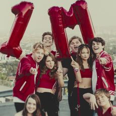 A group photo of The Squad, standing with red balloons shaped as "1 M" in a still from "Bad Influence: The Dark Side of Kidfluencing."