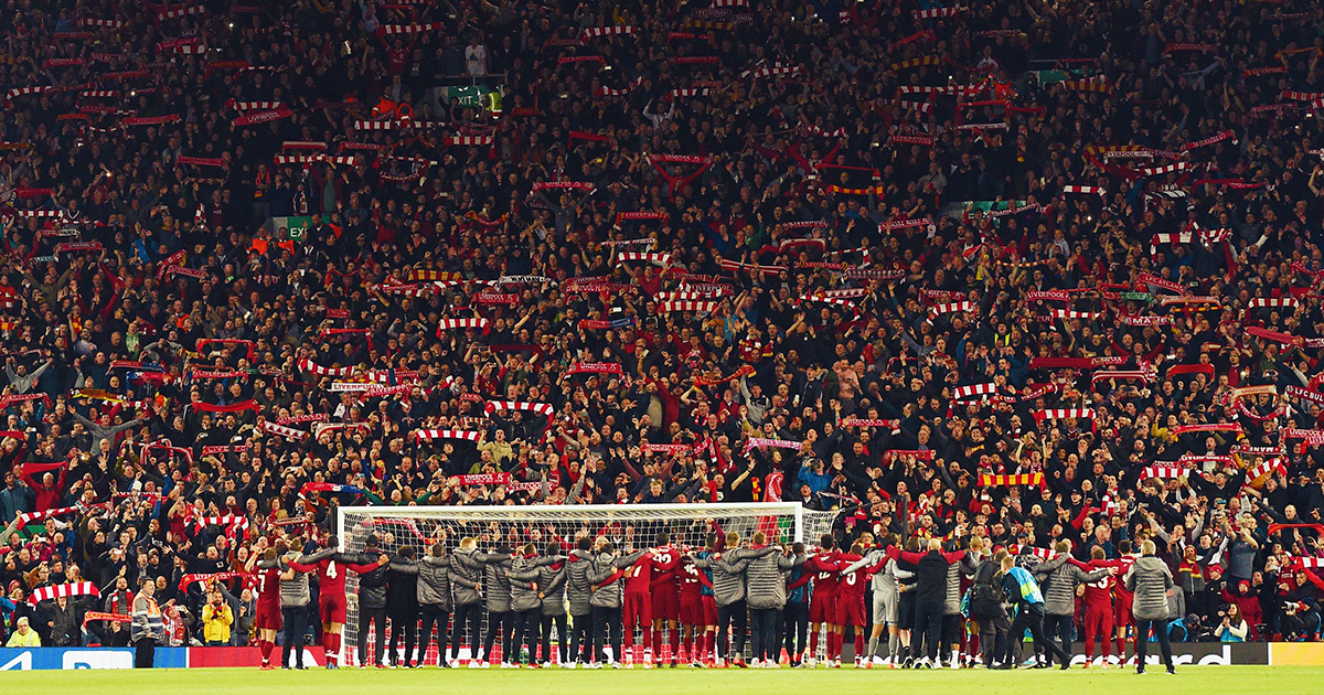 Liverpool squad and backroom staff celebrate in front of the Kop after winning the UEFA Champions league semi-final second leg football match between Liverpool and Barcelona 4-0 at Anfield in Liverpool, north west England on May 7, 2019.