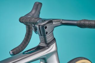 Close up of the Wilier Filante SLR spacers and handlebars shown from the side rear of the bike with a blue background