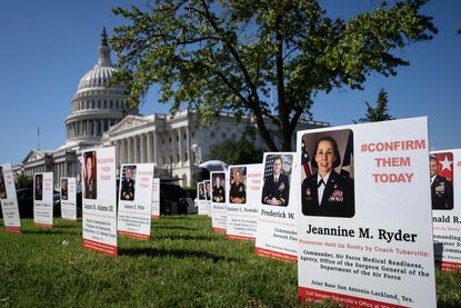 Signs urging Sen. Tommy Tuberville to drop his military promotions hold