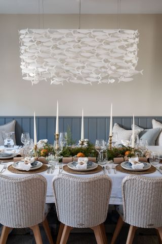 coastal cottage dining room with statement fish shoal light