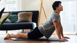 10 stretches to do every day: Image shows man doing yoga pose
