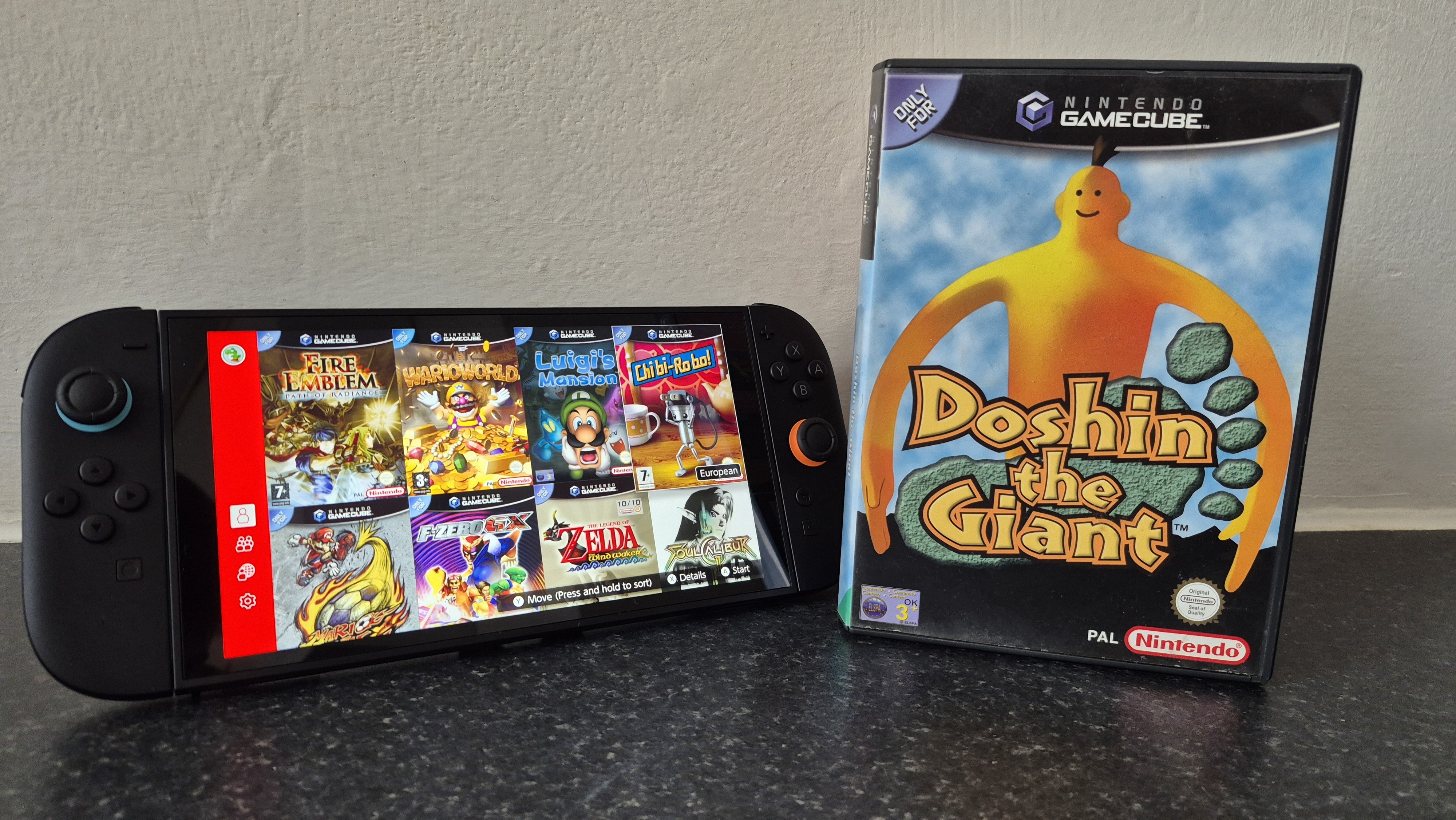 Switch 2 console with GameCube Nintendo Switch Online application on display next to game case for Doshin the Giant