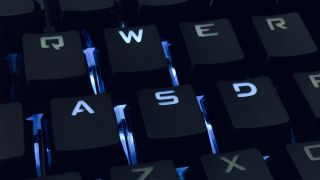 Photo of a backlit mechanical keyboard, focusing on the WASD keys