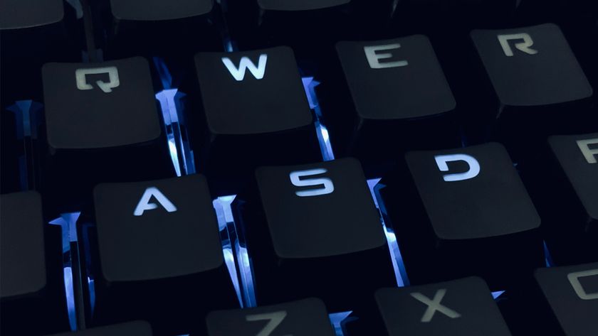Photo of a backlit mechanical keyboard, focusing on the WASD keys