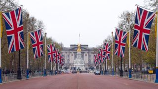 Union Jack flags hanging on The Mall with Buckingham Palace in the background for the Coronation celebrations