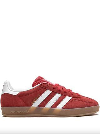 a pair of adidas gazelle sneakers in front of a plain backdrop