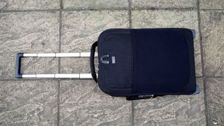 Think Tank Airport International V3.0 travel case on a stone floor