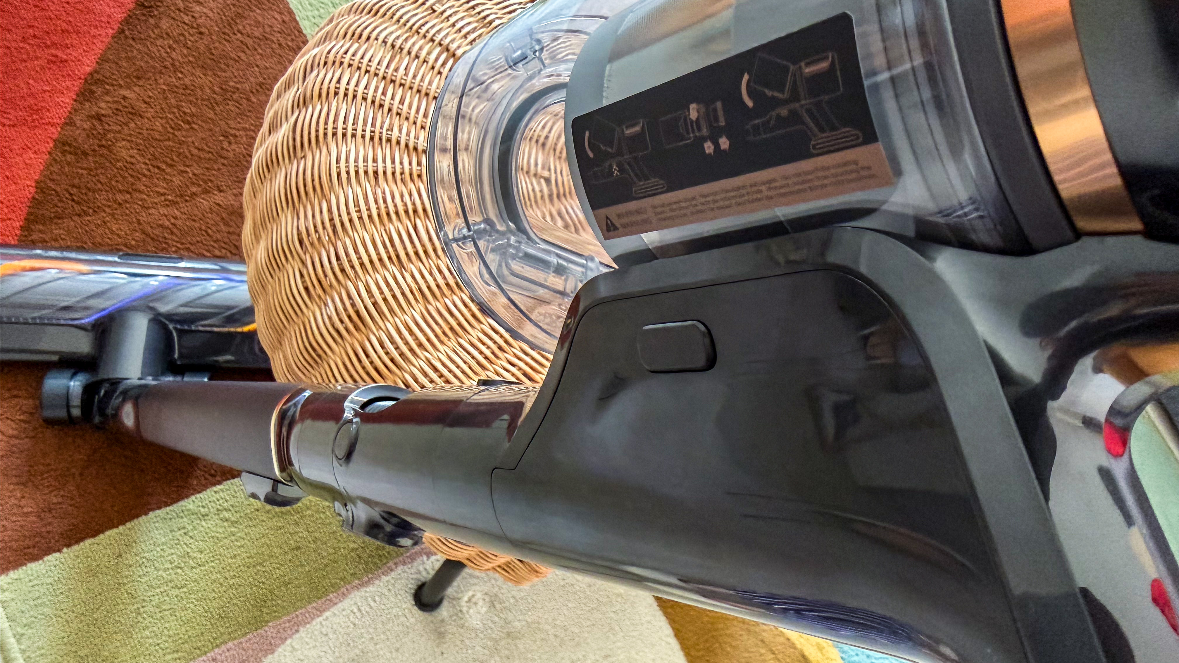 A side button on the Dreame Z50 Station handheld unit to release the dust cup