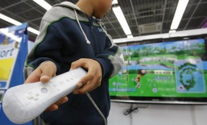 A boy plays the Nintendo Wii game system, which is rumored to be upgraded this year with potentially a HD screen or a more powerful console.