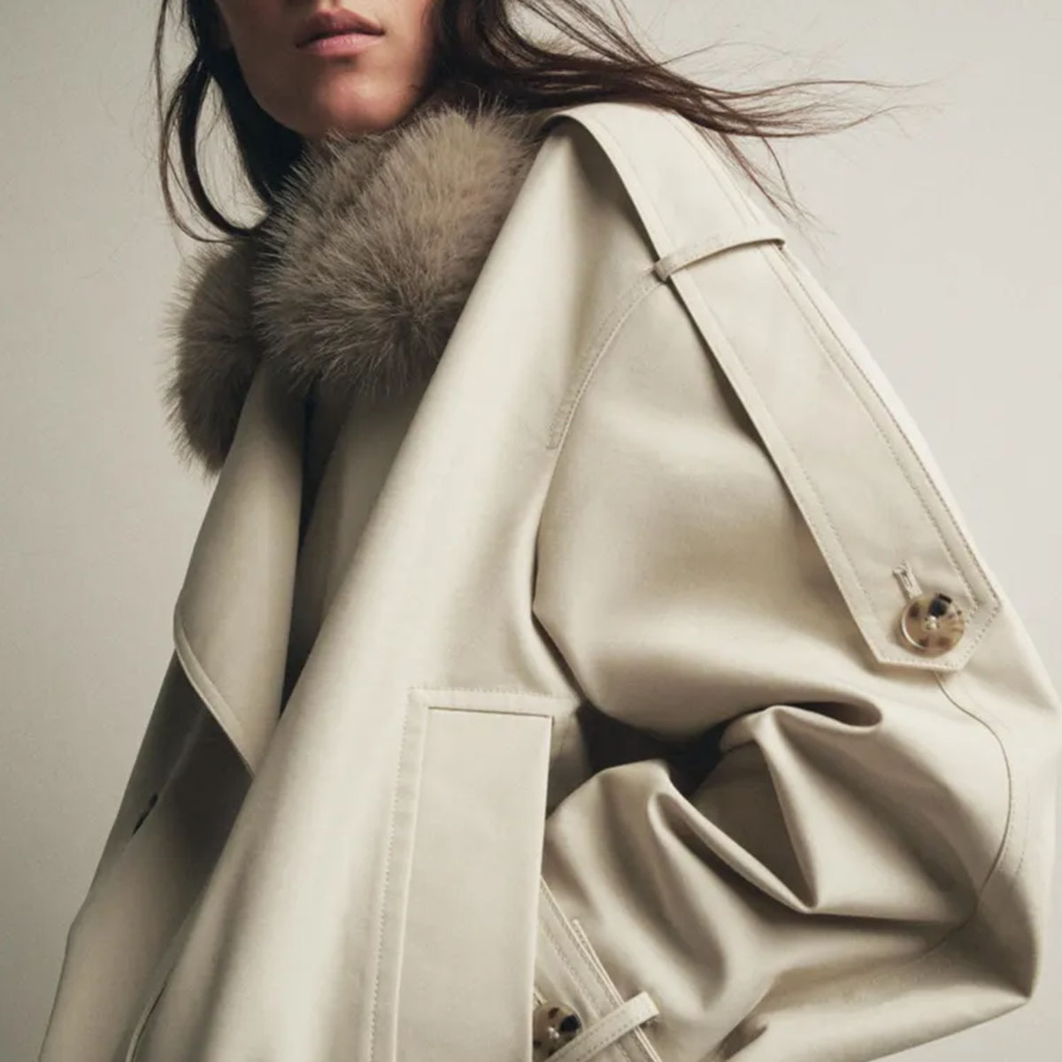 Woman in trench coat and faux fur collar
