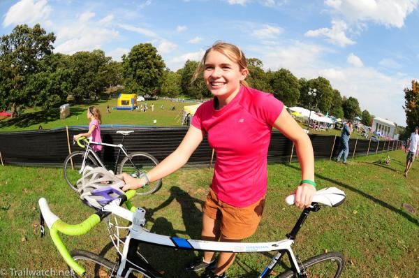 A racer pushes her bike after her 10-12 race
