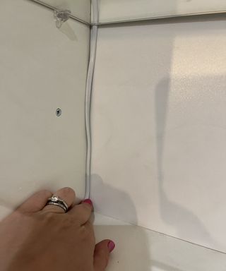 Tracking a white wire through a kitchen cabinet hole