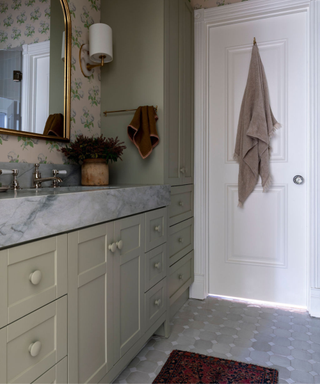 Pale green bathroom with gray marble worktop