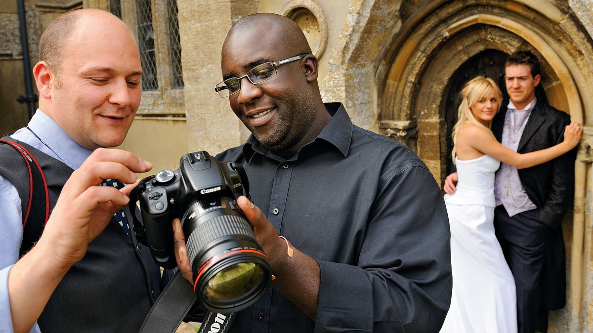 One of the best cameras for wedding photography, being used during a wedding shoot by two photographers