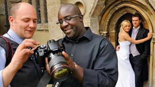 One of the best cameras for wedding photography, being used during a wedding shoot by two photographers