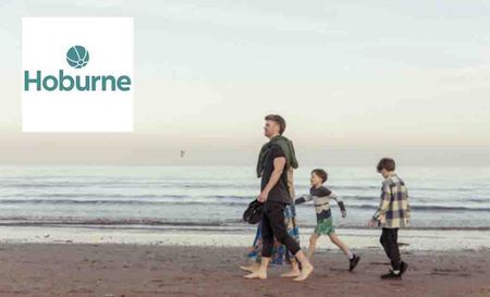 hoburne logo top left with a dad and two kids on a beach