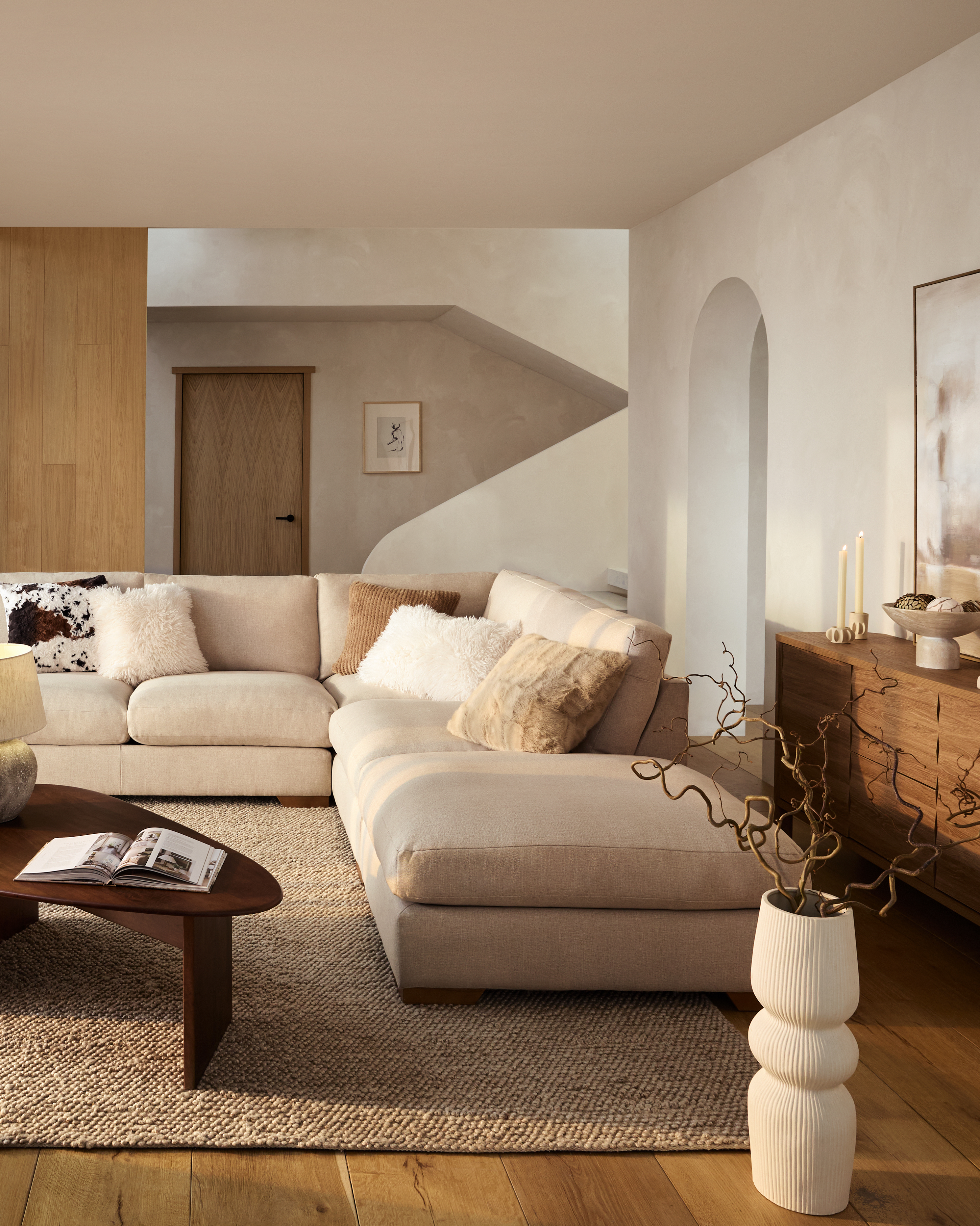 a beige sofa in a modern minimalist living room