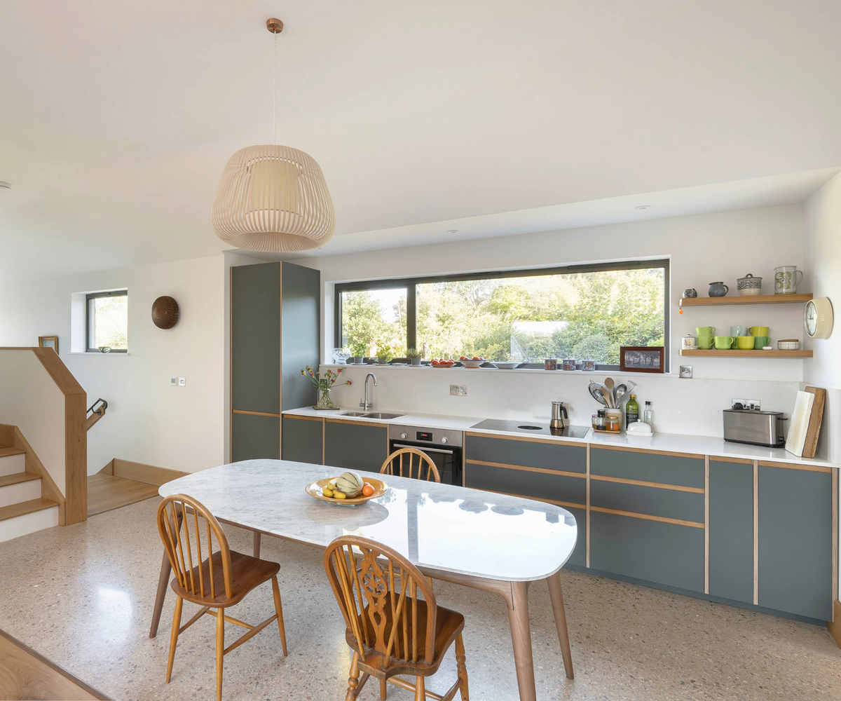 Open plan kitchen diner with grey cabinets