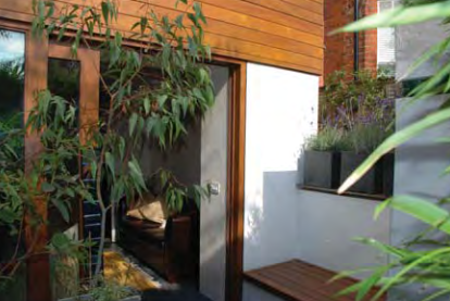 The property is flanked by two sunken courtyards
