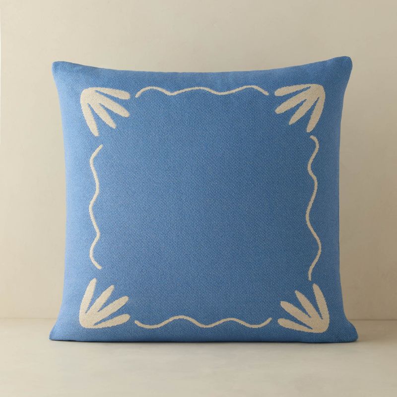 blue square pillow with cream pattern