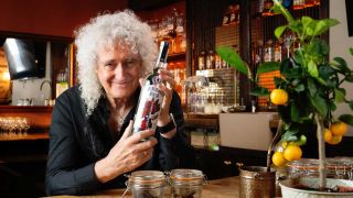Brian May with a bottle of Red Special gin