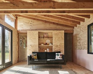 A wooden cabin and sofa