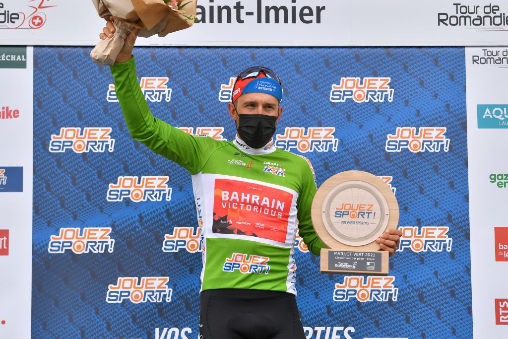 SAINTIMIER SWITZERLAND APRIL 29 Sonny Colbrelli of Italy and Team Bahrain Victorious Green Points Jersey celebrates at podium during the 74th Tour De Romandie 2021 Stage 2 a 1657km stage from La Neuveville to SaintImier Trophy Flowers Mask Covid Safety Measures TDR2021 TDRnonstop UCIworldtour on April 29 2021 in SaintImier Switzerland Photo by Luc ClaessenGetty Images