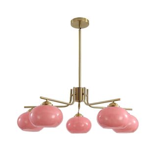 A chandelier with five pink glass lights and a gold base