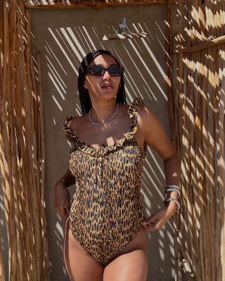 Influencer wears a leopard print swimsuit.