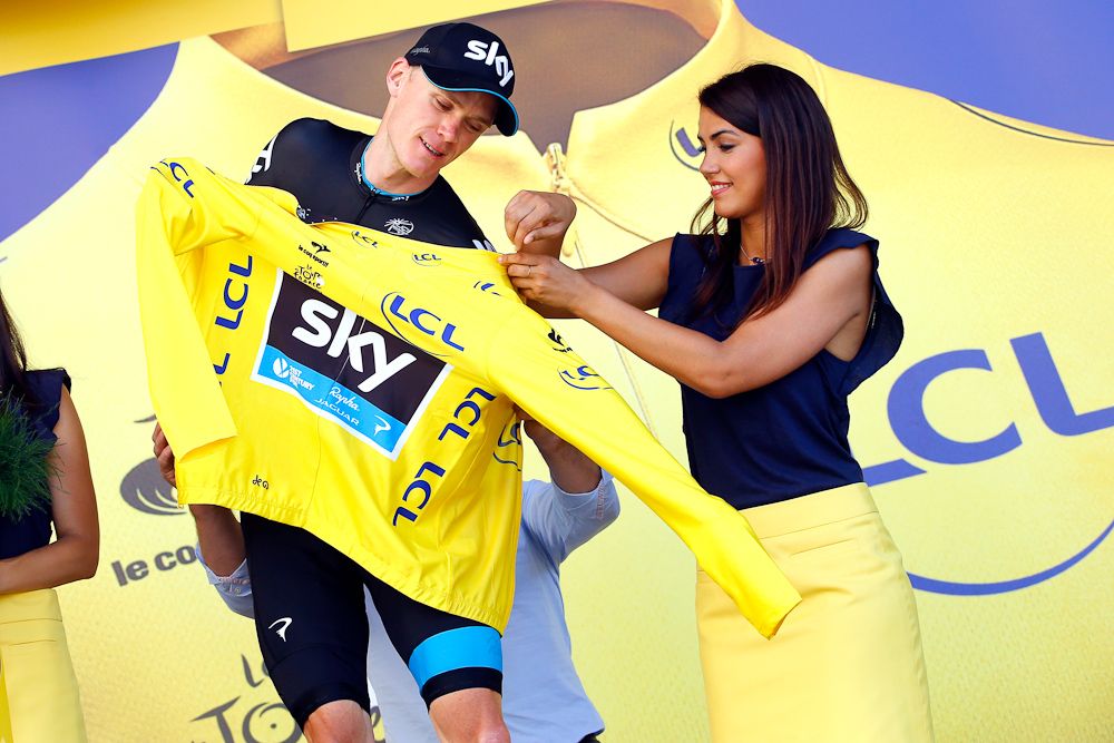 Chris Froome puts on the yellow jersey after stage 11.