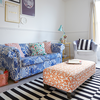 living room with blue floral fabric sofa