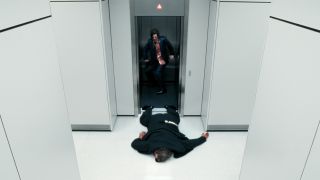 Mister Drummond lying dead on the floor as a bloodied Mark Scout looks down at him in Severance season 2 episode 'Cold Harbor'