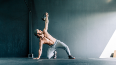 A man performing the Turkish get up core exercise