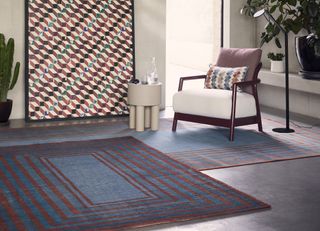 layered geometric rugs in a living room